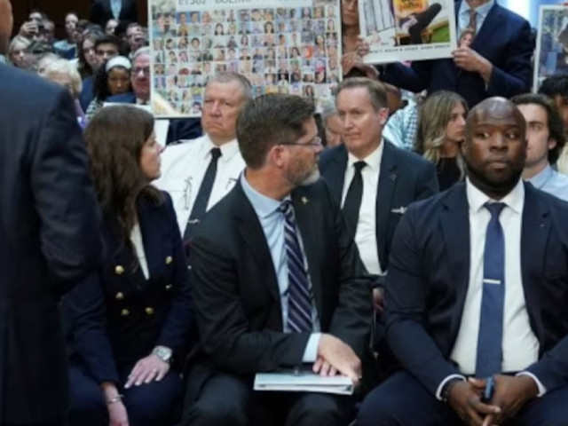 placard with photos of those killed on ethiopian airlines flight 302 is held up during a senate homeland security and governmental affairs committee investigation photo reuters